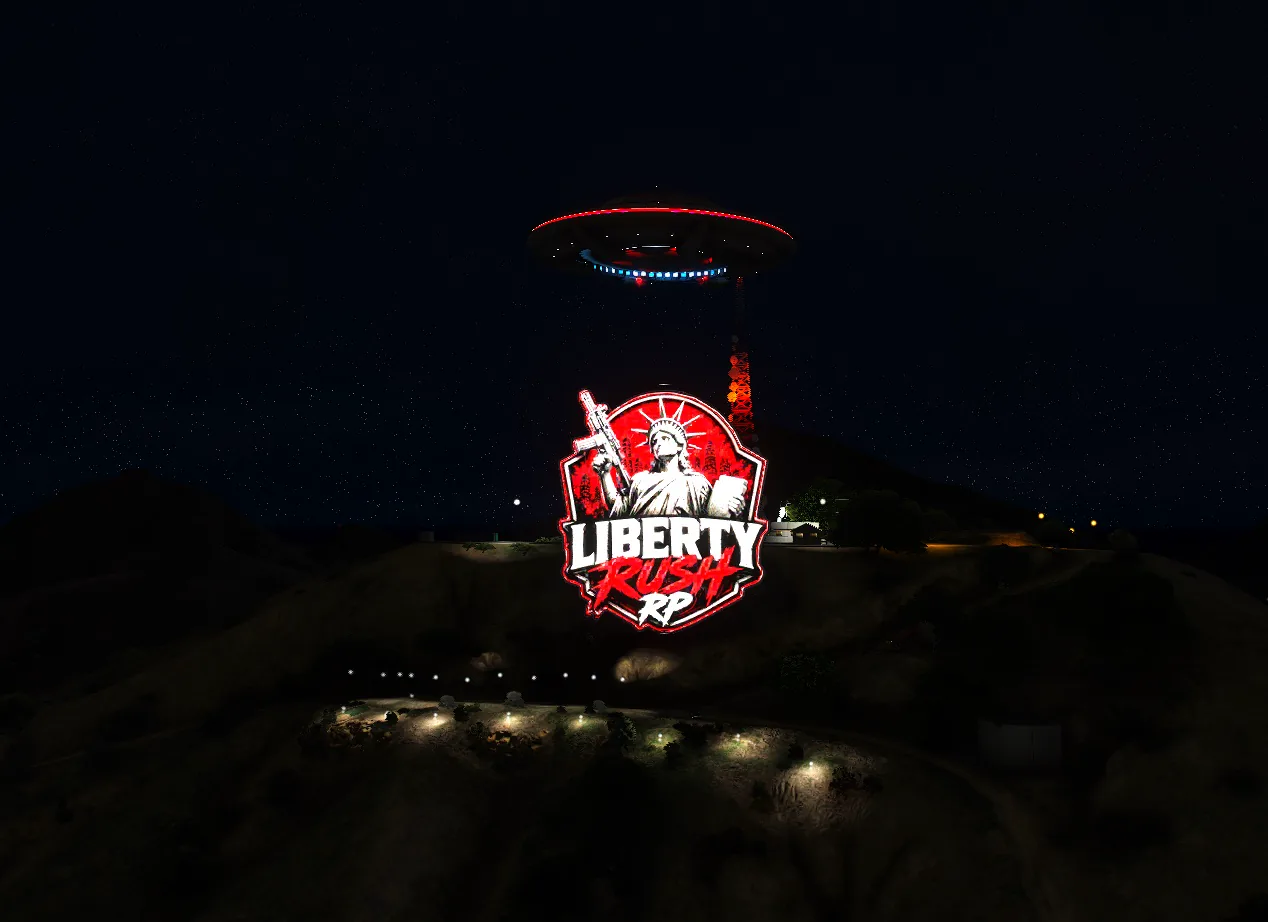 LibertyRush sign and UFO landmark glowing at night